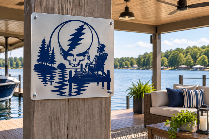 Custom Stainless Lake Scene — A custom navy lake-scene design shown on a furnished covered dock. View the actual sign close-up below.